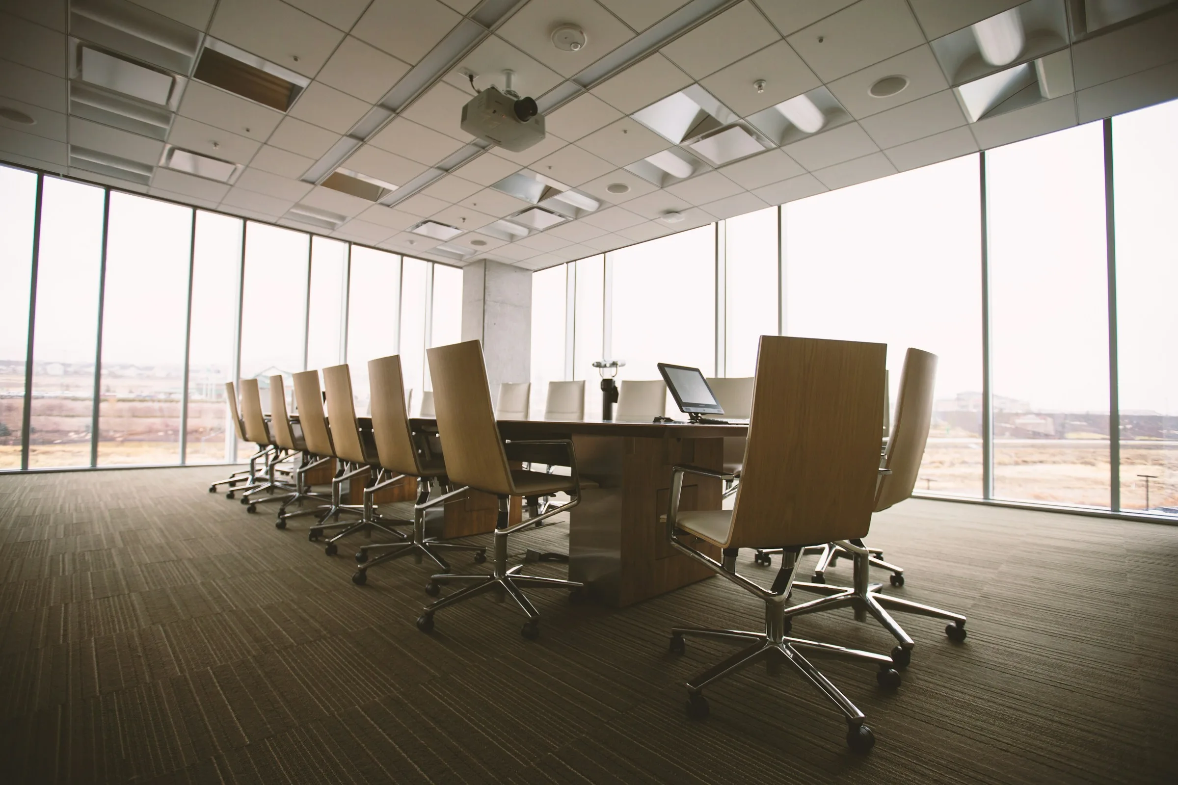 An empty boardroom with floor-to-ceiling windows